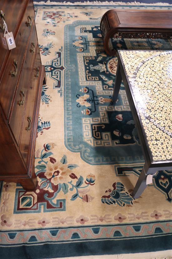 A Chinese blue and cream-ground carpet, 340cm x 244cm